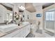 Dual sinks, a soaking tub, and glass-enclosed shower highlight the luxurious primary bathroom at 2402 Raven Croft Ct, Orlando, FL 32837