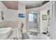 Large soaking tub with a glass enclosed shower highlight the luxurious primary bathroom at 2402 Raven Croft Ct, Orlando, FL 32837