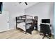 Comfortable bedroom featuring a bunk bed, hardwood floors, and a cozy study space beneath the top bunk at 2402 Raven Croft Ct, Orlando, FL 32837