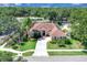 Stunning single-story home boasting lush landscaping, a circular driveway, and a tile roof at 2402 Raven Croft Ct, Orlando, FL 32837
