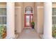 Charming front entrance with brick walkway, front door and decorative pot with lush green plants at 2402 Raven Croft Ct, Orlando, FL 32837