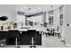 Bright kitchen featuring white cabinets, quartz countertops, tile floors, and a breakfast bar with pendant lighting at 2402 Raven Croft Ct, Orlando, FL 32837