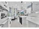 Open kitchen featuring white cabinets, quartz countertops, an island, tile floors, and views into the living room at 2402 Raven Croft Ct, Orlando, FL 32837