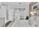 Main bedroom featuring hardwood floors and a sliding barn door leading to the en suite bathroom at 2402 Raven Croft Ct, Orlando, FL 32837