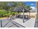 An outdoor kitchen with a grill, refrigerator, sink, dining table and chairs offer backyard enjoyment at 2402 Raven Croft Ct, Orlando, FL 32837