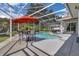 A screened pool area features a dining set and outdoor seating with lush landscaping around the perimeter at 2402 Raven Croft Ct, Orlando, FL 32837