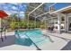 The screened in pool area has seating, landscaping, clear blue water and shaded gazebo at 2402 Raven Croft Ct, Orlando, FL 32837