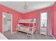 Girly pink bedroom with bunk beds, chandelier and an adjacent bathroom at 2525 Shanti Dr, Kissimmee, FL 34746