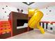 Whimsical bunk room with a built-in slide and custom Disney-themed decor at 2525 Shanti Dr, Kissimmee, FL 34746