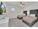 Modern bedroom featuring two beds, neutral tones, and a flat-screen TV at 2525 Shanti Dr, Kissimmee, FL 34746