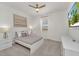 Bright bedroom with a ceiling fan, flat-screen TV, and minimalist décor at 2525 Shanti Dr, Kissimmee, FL 34746