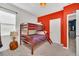 A bedroom with a red accent wall and wooden bunk beds at 2525 Shanti Dr, Kissimmee, FL 34746