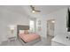Modern bedroom with ensuite bath, gray bedframe, and bright lighting at 2525 Shanti Dr, Kissimmee, FL 34746