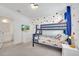 bedroom with Mickey Mouse themed bunk beds and colorful polka dot walls at 2525 Shanti Dr, Kissimmee, FL 34746