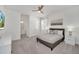 Neutral primary bedroom with ensuite bath, grey bedframe, and bright lighting at 2525 Shanti Dr, Kissimmee, FL 34746