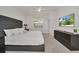 Modern bedroom showcasing a king bed, neutral walls, and large TV screen at 2525 Shanti Dr, Kissimmee, FL 34746