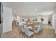 Elegant dining room with a glass table, seating for ten, and an open-concept design at 2525 Shanti Dr, Kissimmee, FL 34746