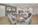 Open-concept dining area with a modern glass table and stylish decor at 2525 Shanti Dr, Kissimmee, FL 34746