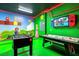 Whimsical game room with colorful decor, custom wall art, and gaming tables at 2525 Shanti Dr, Kissimmee, FL 34746