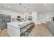 Bright kitchen with white cabinetry, stainless steel appliances, and an island with bar seating at 2525 Shanti Dr, Kissimmee, FL 34746