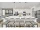 Beautiful kitchen with a large center island, bar stool seating, stainless steel appliances, and modern pendant lighting at 2525 Shanti Dr, Kissimmee, FL 34746