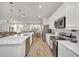 Bright and airy kitchen with stainless steel appliances, a center island, and an adjacent dining area at 2525 Shanti Dr, Kissimmee, FL 34746