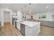 Modern kitchen with white cabinets, stainless steel appliances, and a center island at 2525 Shanti Dr, Kissimmee, FL 34746