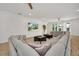 Open-concept living room with large sectional sofa, neutral decor, and hardwood floors at 2525 Shanti Dr, Kissimmee, FL 34746