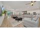 Bright, open-concept living room boasts wood-look tile floors and a large sectional sofa at 2525 Shanti Dr, Kissimmee, FL 34746