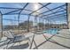 Relaxing screened-in pool and patio area with plenty of space for outdoor lounging at 2525 Shanti Dr, Kissimmee, FL 34746