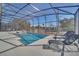 Sparkling pool with screened enclosure and lounge chairs for relaxing at 2525 Shanti Dr, Kissimmee, FL 34746