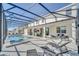 Inviting screened-in pool area with lounge chairs and ample space for outdoor living at 2525 Shanti Dr, Kissimmee, FL 34746