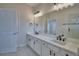 Bright bathroom with double sinks, white cabinets, and modern fixtures at 2673 Calistoga Ave, Kissimmee, FL 34741