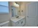 This bathroom has a modern vanity with undermount sink and a window with blinds at 2673 Calistoga Ave, Kissimmee, FL 34741