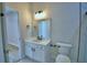Modern bathroom with quartz vanity, black fixtures, marble style walls, and seamless access to other rooms at 2673 Calistoga Ave, Kissimmee, FL 34741