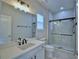 Bathroom with white cabinets, marble countertops, and a glass shower at 2673 Calistoga Ave, Kissimmee, FL 34741