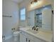 Bathroom features a vanity with undermount sink and framed mirror plus a toilet at 2673 Calistoga Ave, Kissimmee, FL 34741