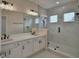 Elegant bathroom boasts a double sink vanity, large mirror and sleek glass shower at 2673 Calistoga Ave, Kissimmee, FL 34741
