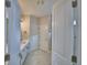 Bathroom with double door entry, white cabinets, granite counters and marble floors at 2673 Calistoga Ave, Kissimmee, FL 34741