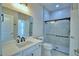 Well lit modern bathroom featuring marble style walls, quartz vanity, black fixtures and a glass enclosed shower at 2673 Calistoga Ave, Kissimmee, FL 34741