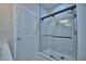 The bathroom features a glass shower with a marble surround and black hardware at 2673 Calistoga Ave, Kissimmee, FL 34741