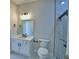 Modern bathroom features marble style walls, quartz vanity, and black fixtures with sleek glass enclosed shower at 2673 Calistoga Ave, Kissimmee, FL 34741