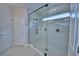 Bathroom featuring frameless glass shower with marble surround and modern fixtures at 2673 Calistoga Ave, Kissimmee, FL 34741