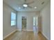 Bright bedroom with wood-look flooring, recessed lighting, ceiling fan and access to bathroom and balcony at 2673 Calistoga Ave, Kissimmee, FL 34741