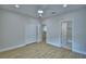 This bedroom has an ensuite bath and closet with wood-look floors and modern ceiling fan at 2673 Calistoga Ave, Kissimmee, FL 34741