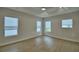 Spacious bedroom with wood floors, tray ceiling, ceiling fan, recessed lights and bright windows at 2673 Calistoga Ave, Kissimmee, FL 34741