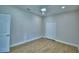 Clean bedroom with wood-look flooring and neutral walls, with ceiling fan and ample closet space at 2673 Calistoga Ave, Kissimmee, FL 34741