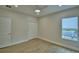 Bright bedroom with light wood flooring, closet with white bi-fold doors, and a sunlit window at 2673 Calistoga Ave, Kissimmee, FL 34741