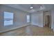 Bright bedroom features wood-look flooring, two windows, and a modern ceiling fan at 2673 Calistoga Ave, Kissimmee, FL 34741