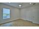 Bedroom with window and closet has wood-look floors and neutral paint scheme at 2673 Calistoga Ave, Kissimmee, FL 34741